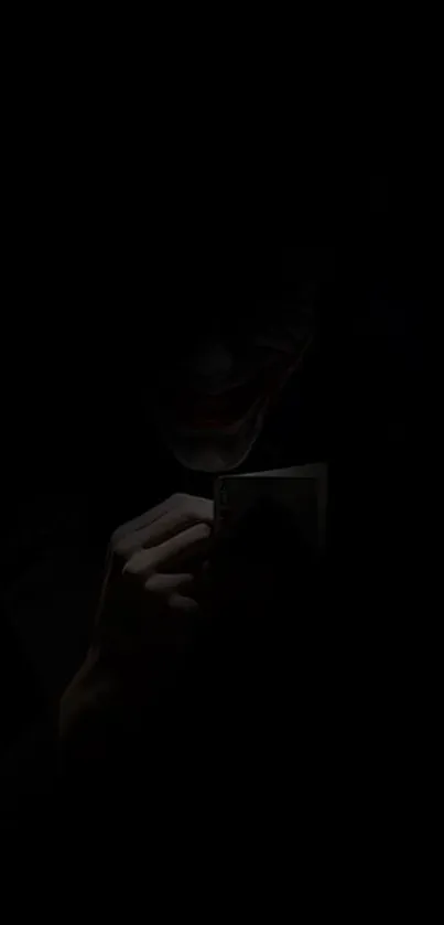 Dark themed Joker wallpaper with playing card.