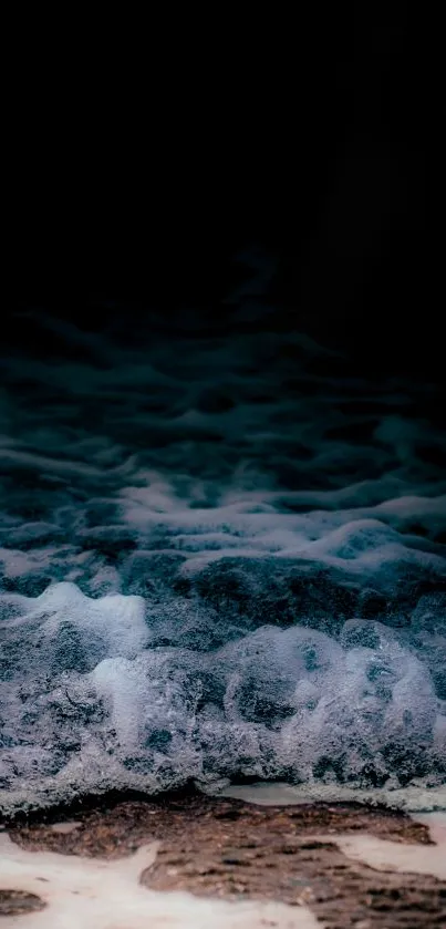 Dark ocean waves crashing under the night sky with foam along the shore.