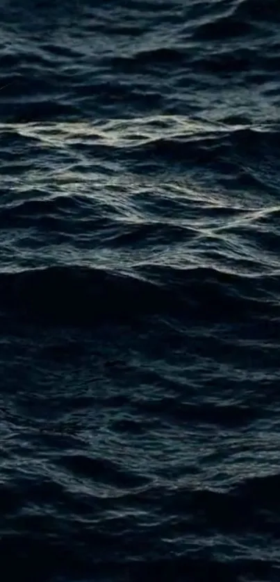 Dark deep blue ocean waves at sea creating a calming texture.