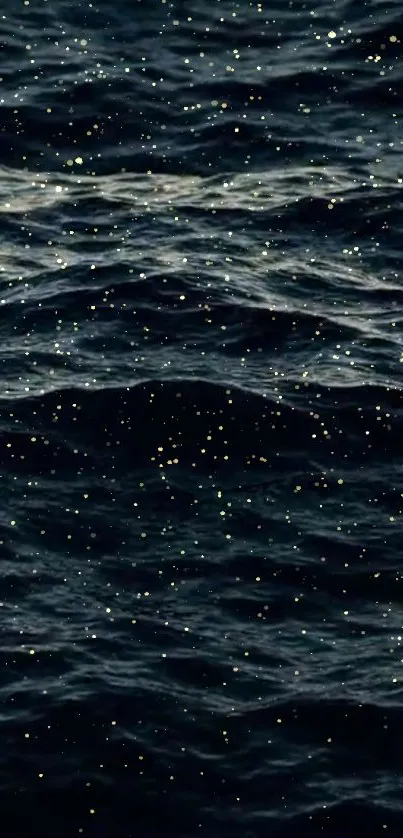 Dark ocean waves with shimmering golden specks wallpaper.