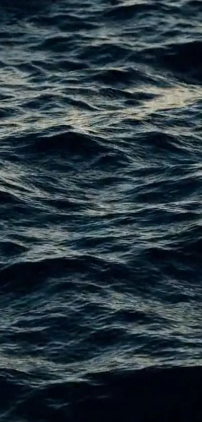 Dark blue ocean waves creating a calming mobile background.