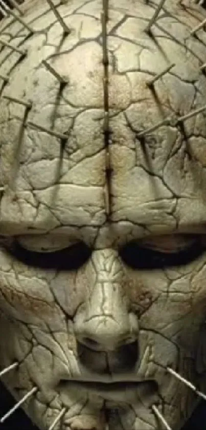 Dark sculpted face with pins wallpaper.