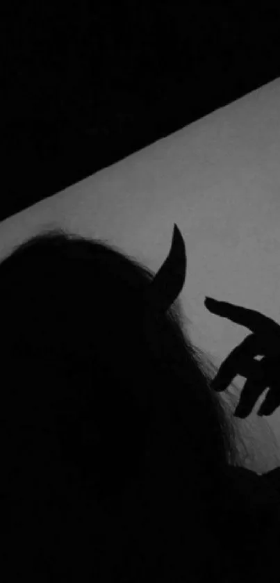 Dark silhouette of a figure with horns, evoking a mysterious aesthetic.