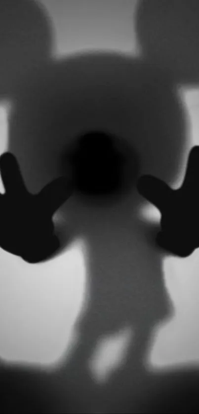 Dark silhouette of a cartoon character with hands outstretched.