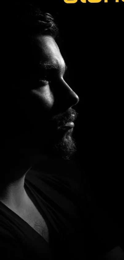 Silhouette of a man against a black background with dramatic lighting.