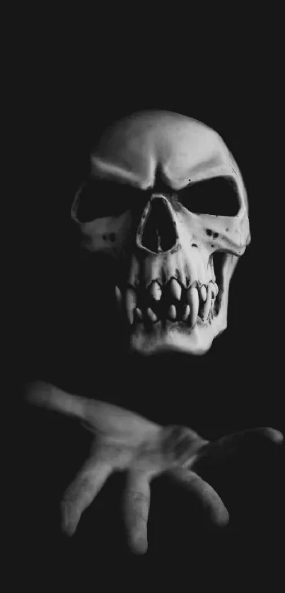 Dark skull extends a hand on a black background wallpaper.