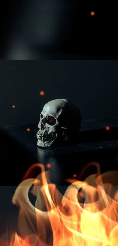 Dark skull with flames on black background wallpaper.