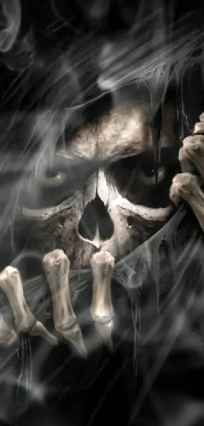 Eerie dark skull with bony hands mobile wallpaper.