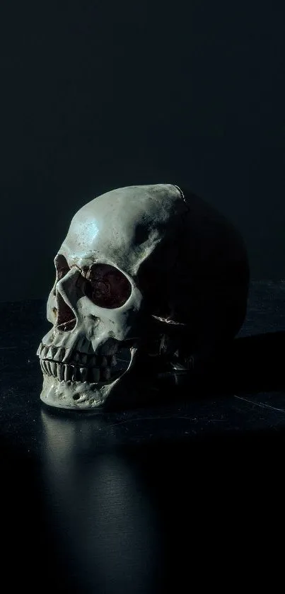 Dark skull on black surface, eerie art background.