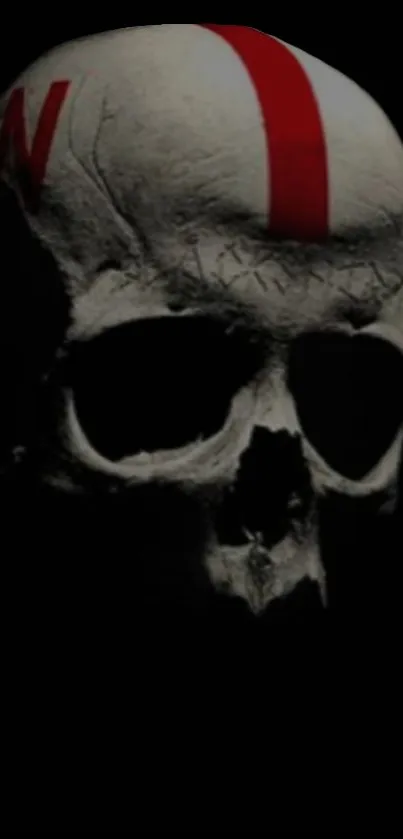 Eerie skull wallpaper with red stripe on black background.