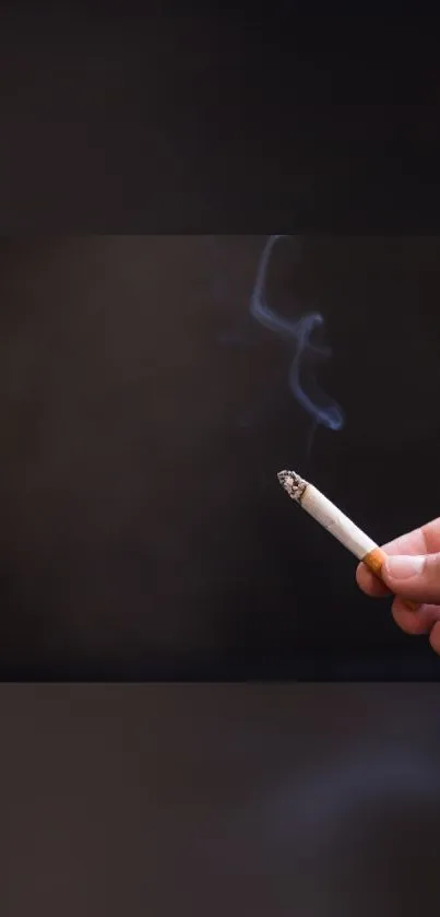 Hand holding a lit cigarette with smoke against a dark brown background.