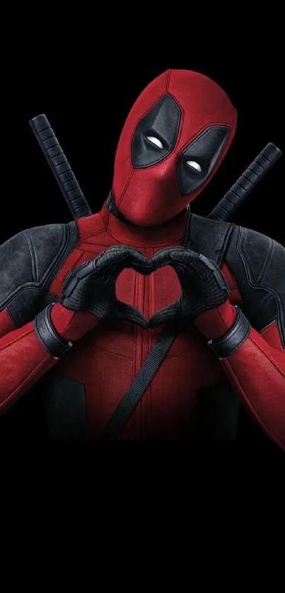 Deadpool making a heart gesture on a black background.