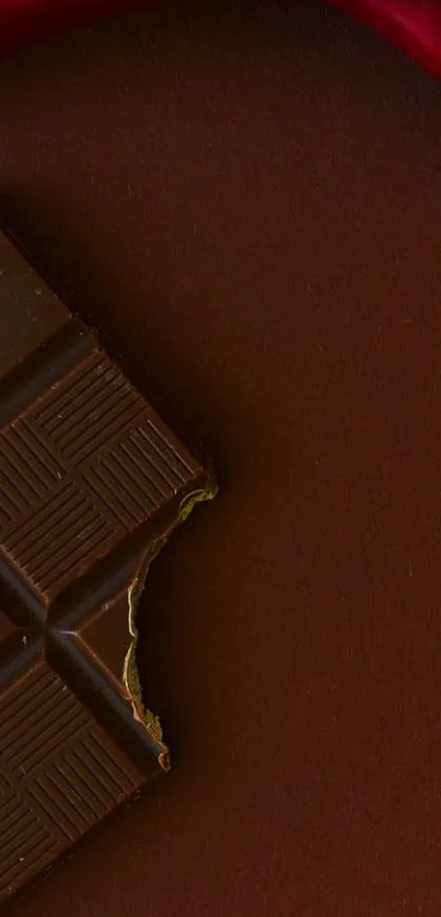 Rich dark chocolate bar against a deep brown background wallpaper.