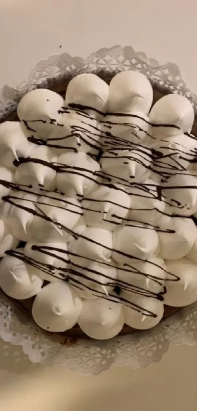 Meringue dessert with chocolate drizzle on mobile wallpaper.