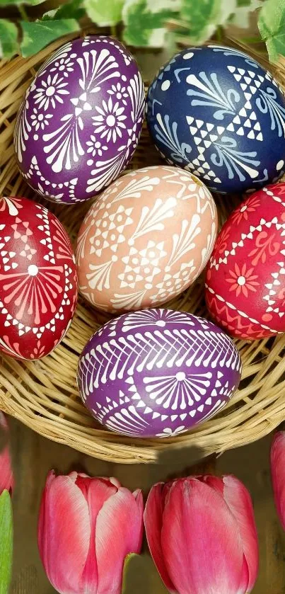 Colorful Easter eggs in a basket with tulips and leaves in the background.