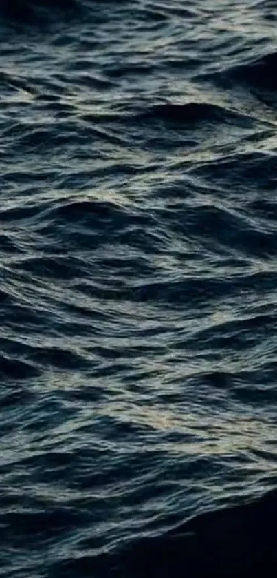 Mobile wallpaper featuring deep blue ocean waves and serene water texture.