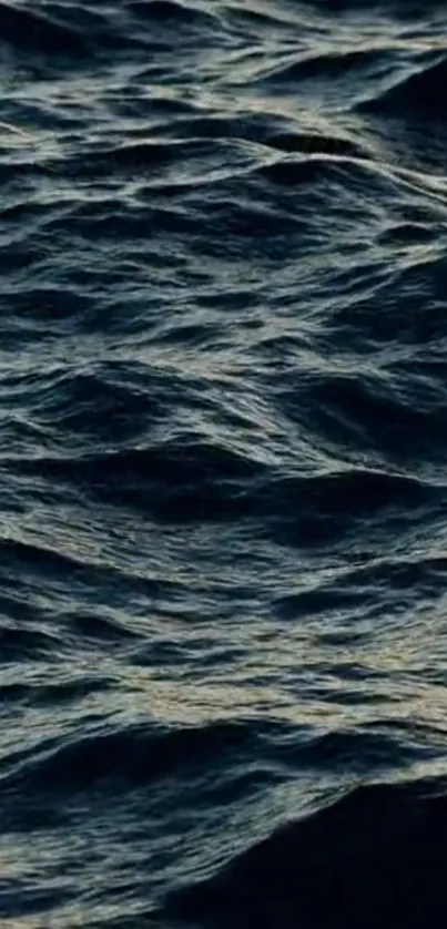 A serene dark blue ocean waves wallpaper for mobile devices.