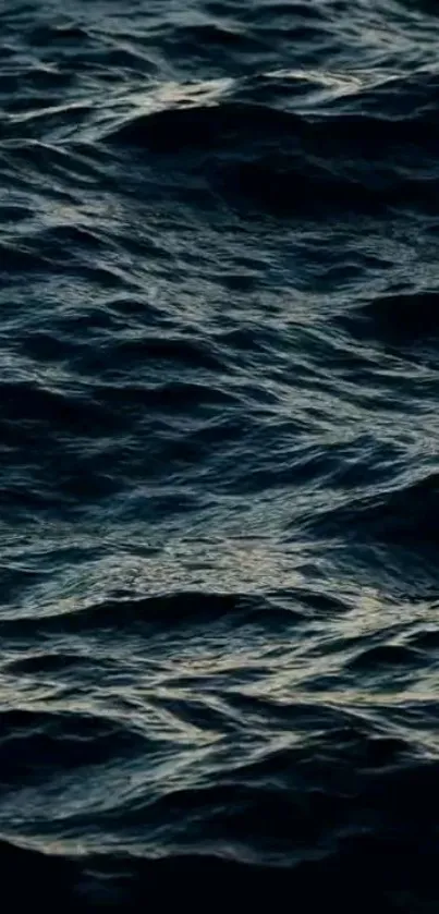 Dark blue ocean waves mobile wallpaper with textured ripples.