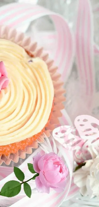 Cupcake with pink roses and ribbons on a glass plate.