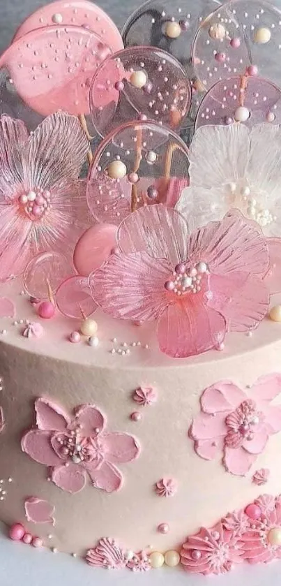 Elegant pink floral cake with decorative flowers.