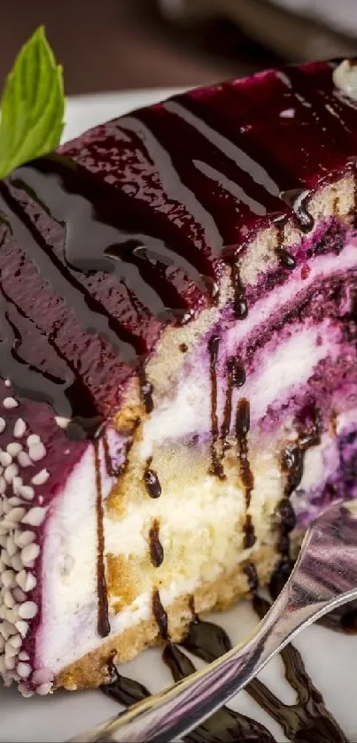 Slice of cheesecake with berry glaze and chocolate drizzle on a plate.