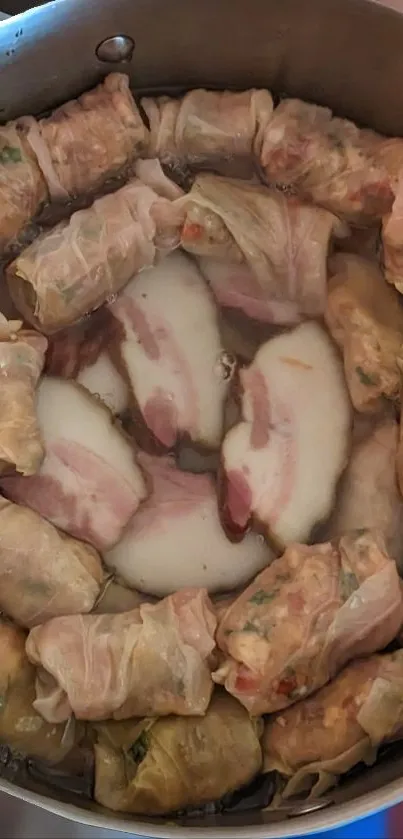 Overhead view of cabbage rolls in a pot.