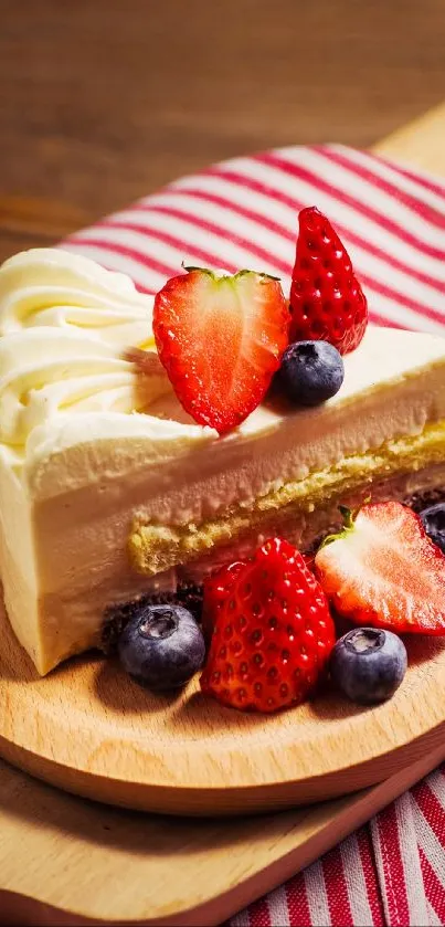 Vanilla cake with strawberries and blueberries on a wooden tray.