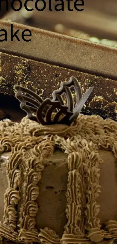 A chocolate cake with decorative icing alongside rich chocolate bars.