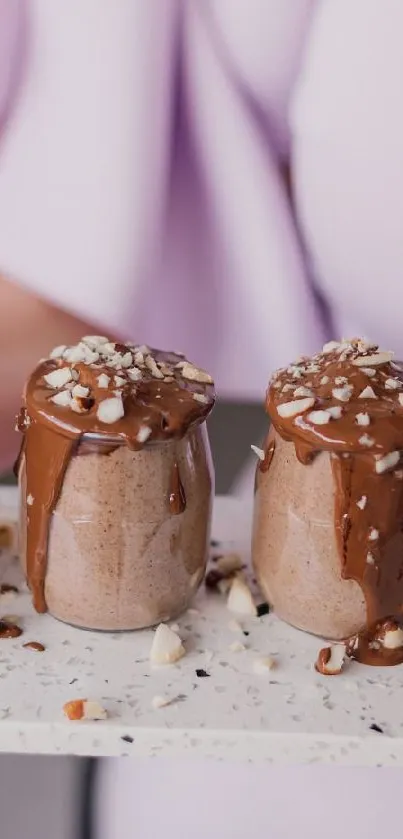 Chocolate desserts with nut toppings on a tray.