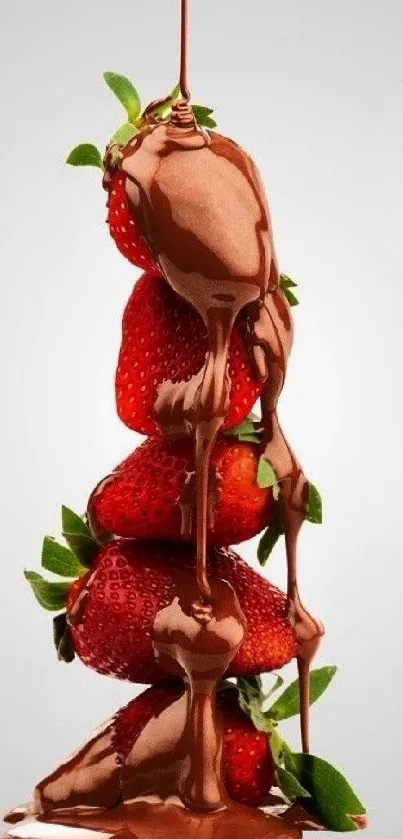 Chocolate flowing over stacked strawberries on a soft background.