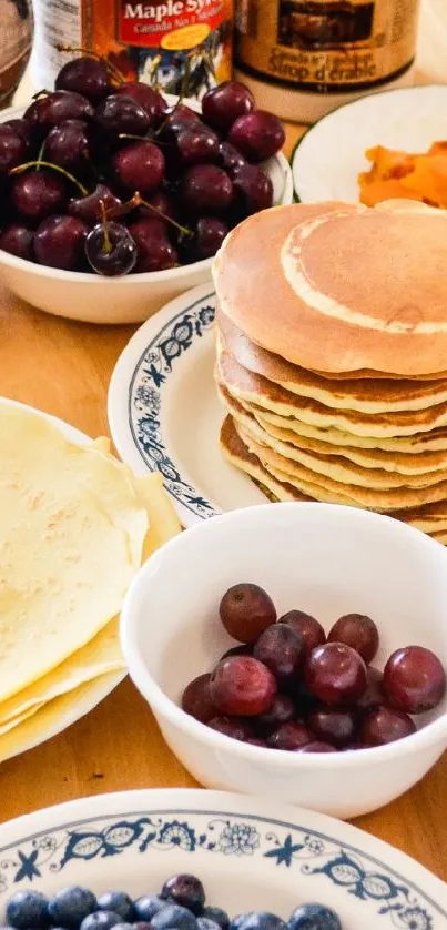 Breakfast table with pancakes, crepes, and fresh fruits.