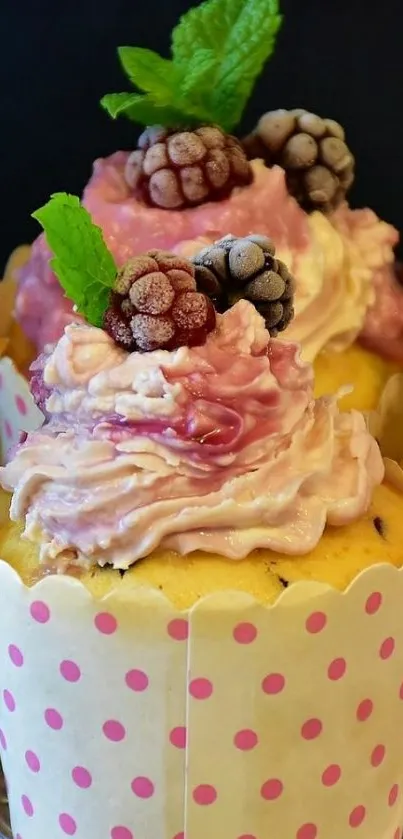 Cupcake with pink frosting and berries on top.