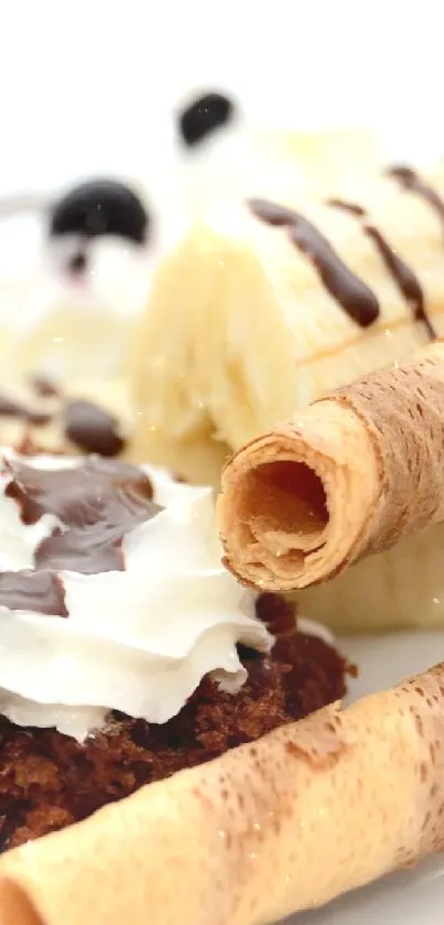 Close-up of delicious dessert with bananas, cream, and wafer rolls on a white plate.