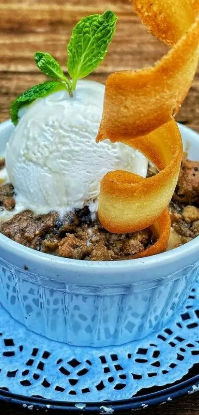 Delicious dessert with ice cream and mint garnish in a blue bowl.