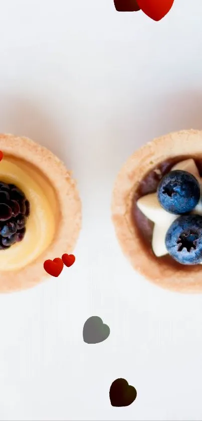 Four colorful dessert tarts with berries on a white background.