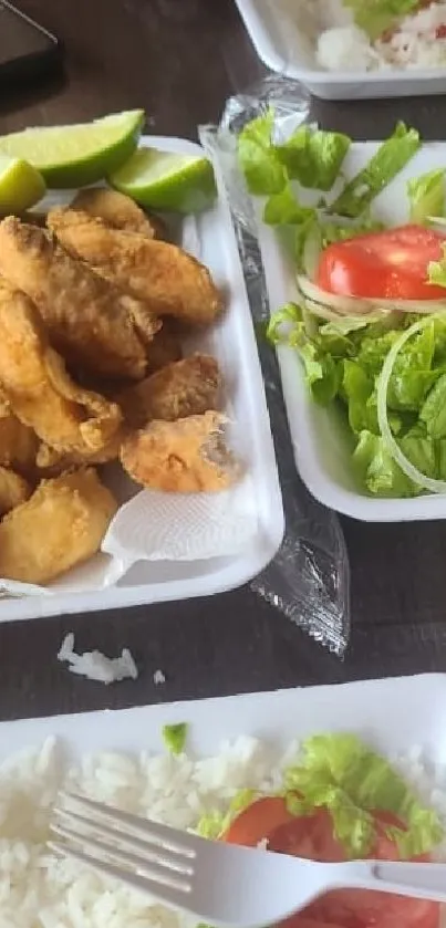 Fried chicken served with fresh salad and rice.