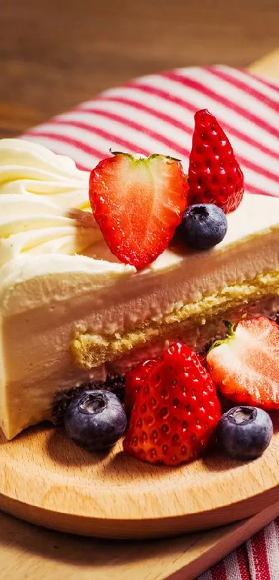 Slice of cake with strawberries and blueberries on a wooden board.