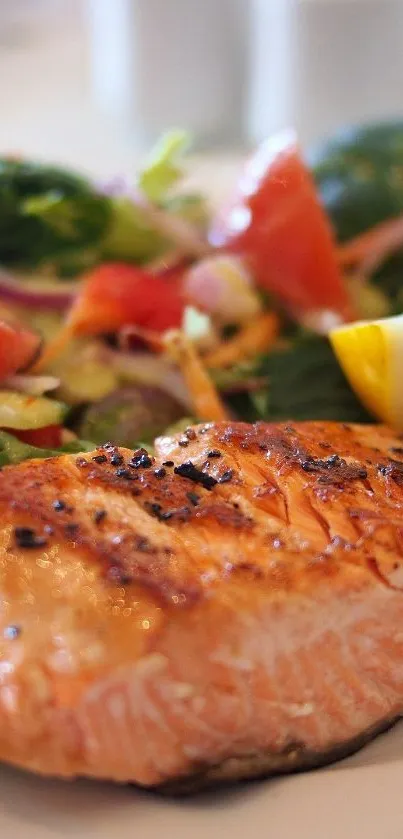 Grilled salmon with a vibrant salad of greens, tomatoes, and lemon slices.