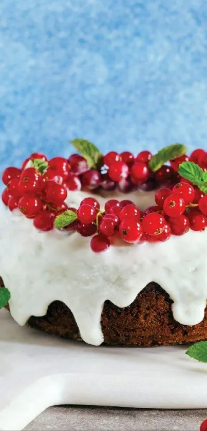 Iced cake with red berries and mint.