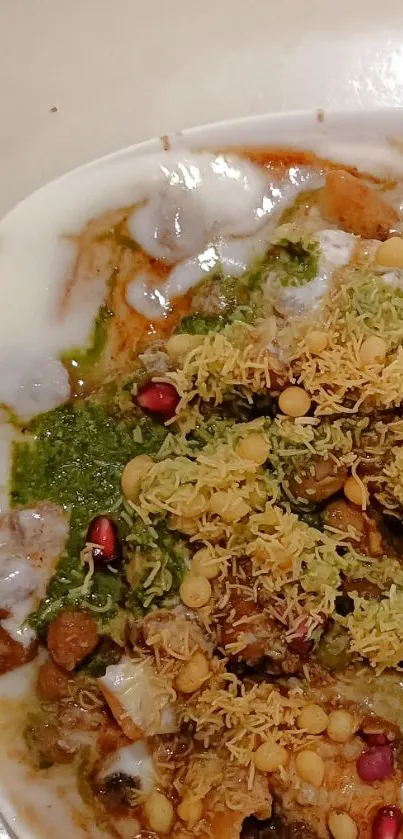 Vibrant Indian chaat with herbs and sauces displayed in a bowl.