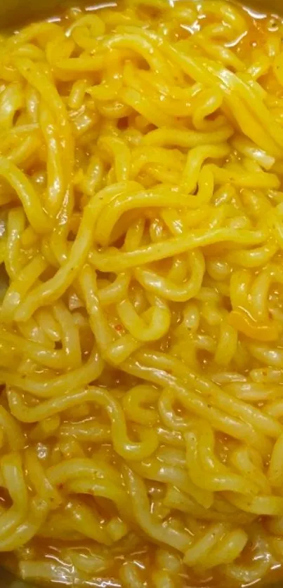 Close-up of golden yellow noodles in a bowl.