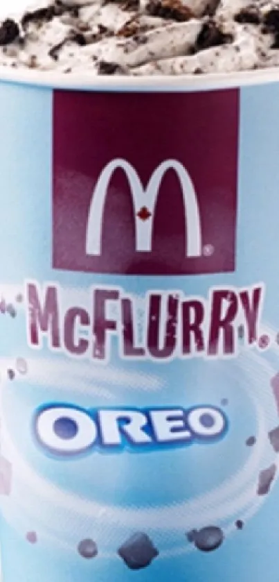 Sky blue cup of Oreo McFlurry topped with crushed cookies.