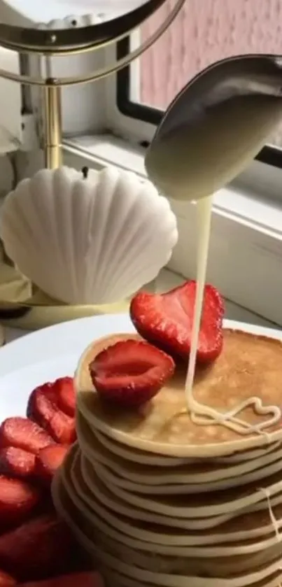 Stack of pancakes with strawberries and cream drizzle.