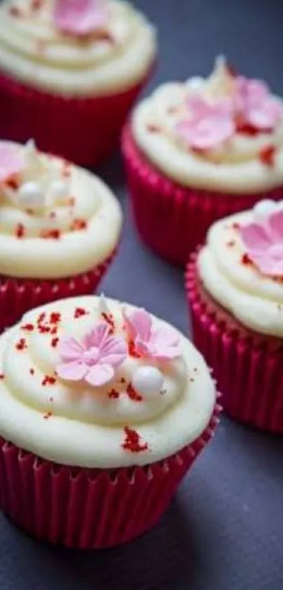 Pink cupcakes with creamy icing and sugar flowers wallpaper.