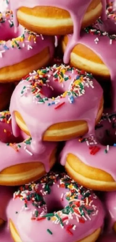 Stack of pink glazed donuts with colorful sprinkles.