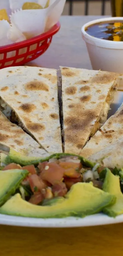 A mouth-watering quesadilla served with avocado on a plate.