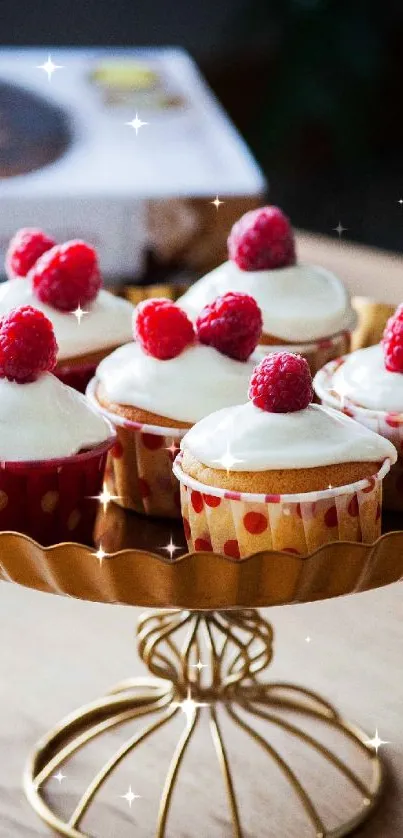 Cupcakes with raspberry toppings on a gold stand.