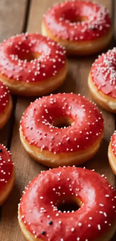 Red iced donuts on a wooden background.