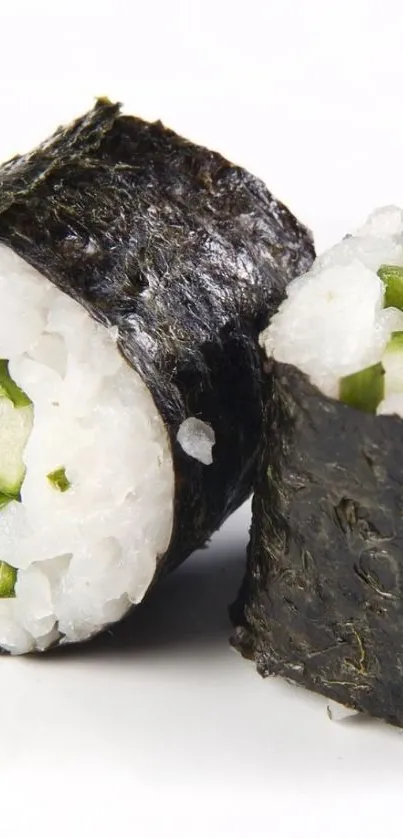 Close-up image of sushi rolls with rice and green veggies on a stark white background.