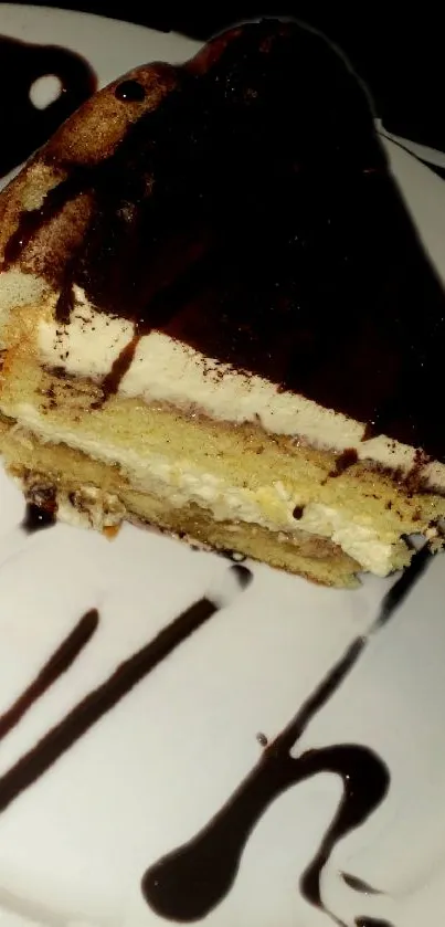 Slice of tiramisu with chocolate topping on a white plate.